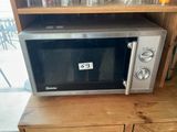 a microwave sitting on top of a wooden table