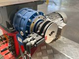 an image of a machine that is working on a piece of metal