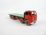 a red toy truck with a green bed on a white surface