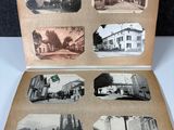 an old photo of an open book with pictures of buildings on it