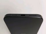 the back of a black iphone with a small hole in the middle of it