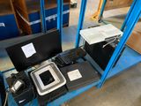 a blue shelf with a computer and other electronics on it