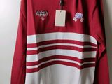 a red and white striped sweater with a tag on it