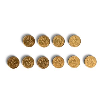 a group of six gold coins sitting on top of a white surface