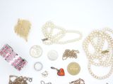 many different types of jewelry on a white surface