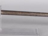 an old gun with a wooden handle on display on a white surface