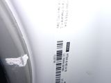 a close up of a white toilet with a barcode on it