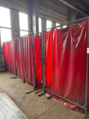 many red privacy screens in a room with windows