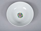 a white bowl with a colorful design on the inside of it