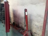 a red pole that is leaning against a wall