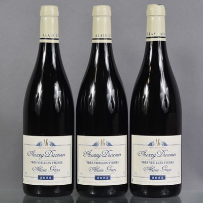 three bottles of wine are lined up on a table