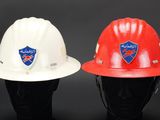 two white and red hard hats sitting next to each other
