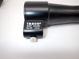 a black blow dryer sitting on a table next to a pair of scissors