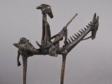 bronze statue of a man riding a horse with a bird on his back