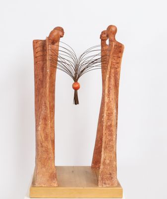 an image of a sculpture of two people with a tree on top of them