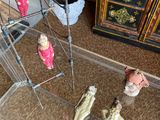 three figurines in a clear display case on the floor
