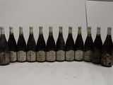bottles of wine are lined up in a row on a table