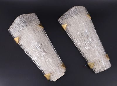 deux appliques en verre transparent ornées de finitions dorées, montées sur un support noir
