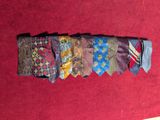 a pile of ties on a red table cloth