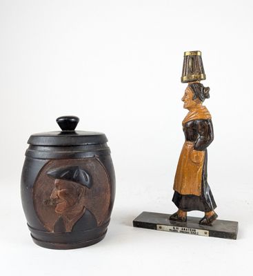 pair of wooden figurines of a man and a woman with a lamp on their head