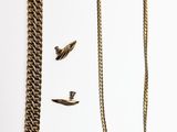 un collier et une chaîne posés sur une surface blanche