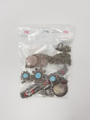 a bag of assorted jewelry sitting on a table