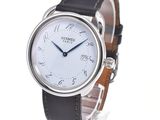 a close up of a wrist watch with a white dial
