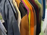 a lot of clothes hanging on a rack in a store