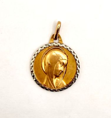 a close up of a gold medal on a white surface