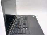 a laptop that is open on a white surface