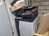 a pile of boxes and a printer on the floor