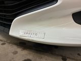 a close up of a white car with a number plate on it
