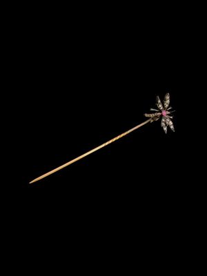 une image représentant un bâton orné d'une fleur, sur fond noir
