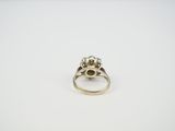 a close up of a diamond ring on a white surface