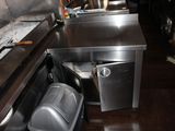 a trash can in the middle of the kitchen