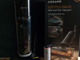 a vacuum that is sitting on a table next to a book