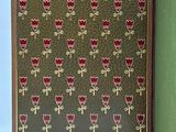 an open book with a pattern of red flowers on a green cover