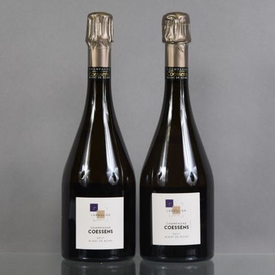 two bottles of wine sitting on top of a table next to each other