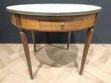 a small table with a marble top on a wooden floor