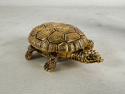 gold turtle figurine on a white background