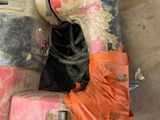 a dirty motor scooter that is sitting on the floor