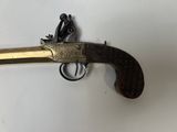a close up of a gun on a white surface with a white background