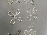 several different types of hair clips sitting on top of a metal surface