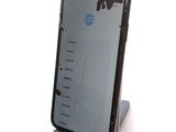 a cell phone with a broken screen sitting on a stand