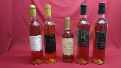 six bottles of wine are lined up in a row on a pink background