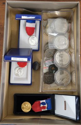 a box full of coins and other items on a table