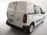 the back of a white van parked in a white room