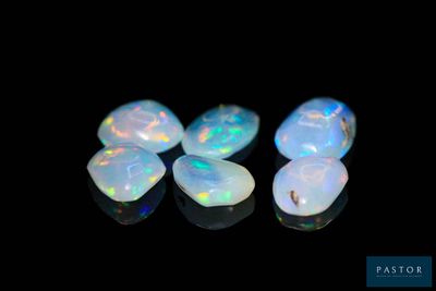a group of white oplite stones on a black surface