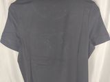 a grey shirt hanging on a hanger on a curtain