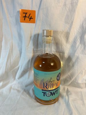 a bottle of rum that is sitting on a white sheet